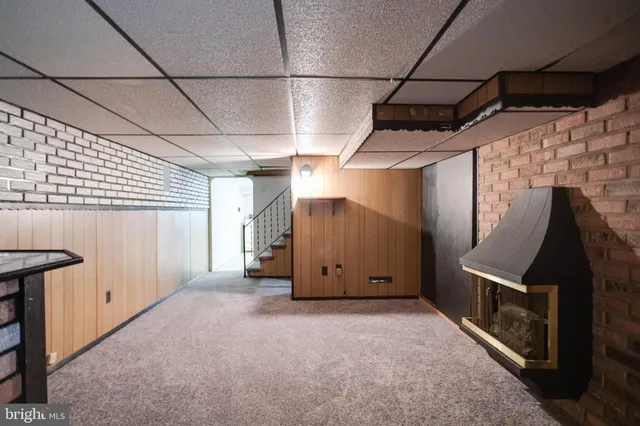 a kitchen with a sink a stove a refrigerator and white cabinets