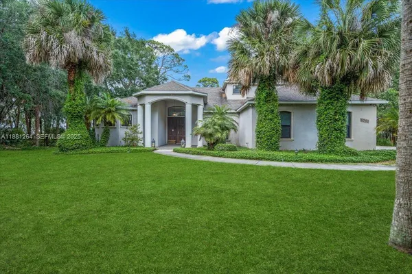 a front view of a house with a garden