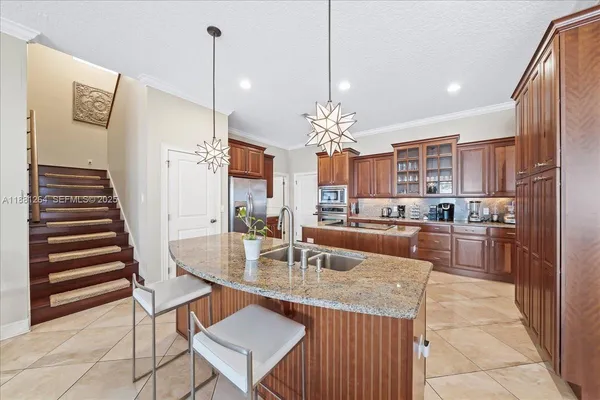 a large kitchen with a large counter top appliances and cabinets