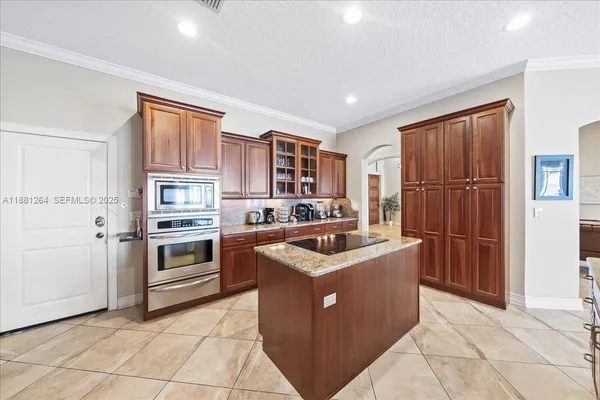 a kitchen with stainless steel appliances granite countertop a refrigerator and cabinets