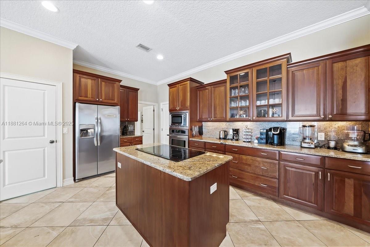 6340 Highway 1 Cocoa, FL 32927 - Photo 15 of 54 a kitchen with stainless steel appliances granite countertop a refrigerator and cabinets