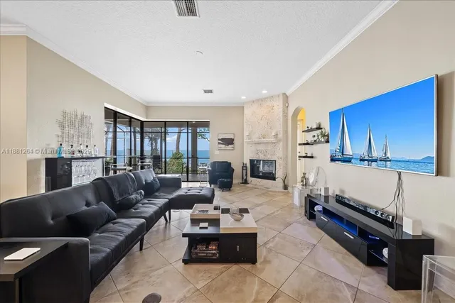 a living room with furniture and a view of kitchen