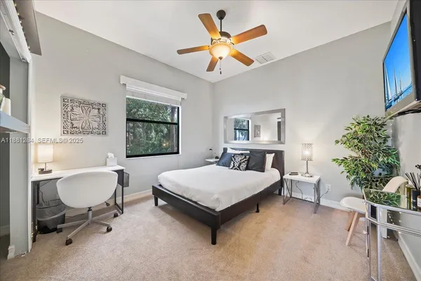 a bed sitting in a bedroom next to a window