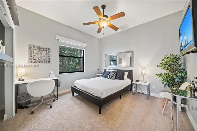 a bed sitting in a bedroom next to a window