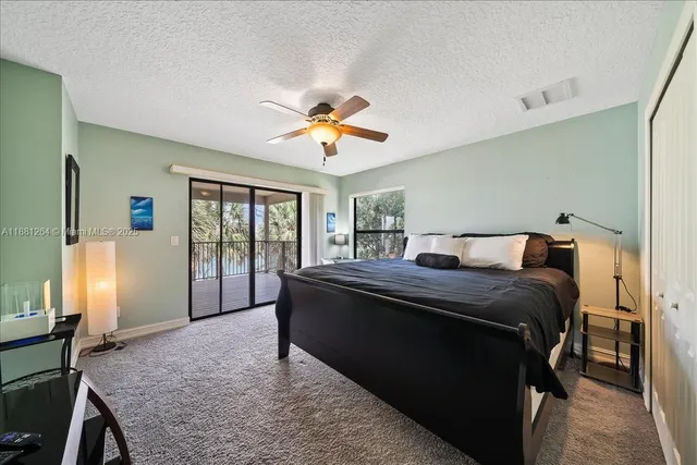 a living room with furniture a rug and a ceiling fan