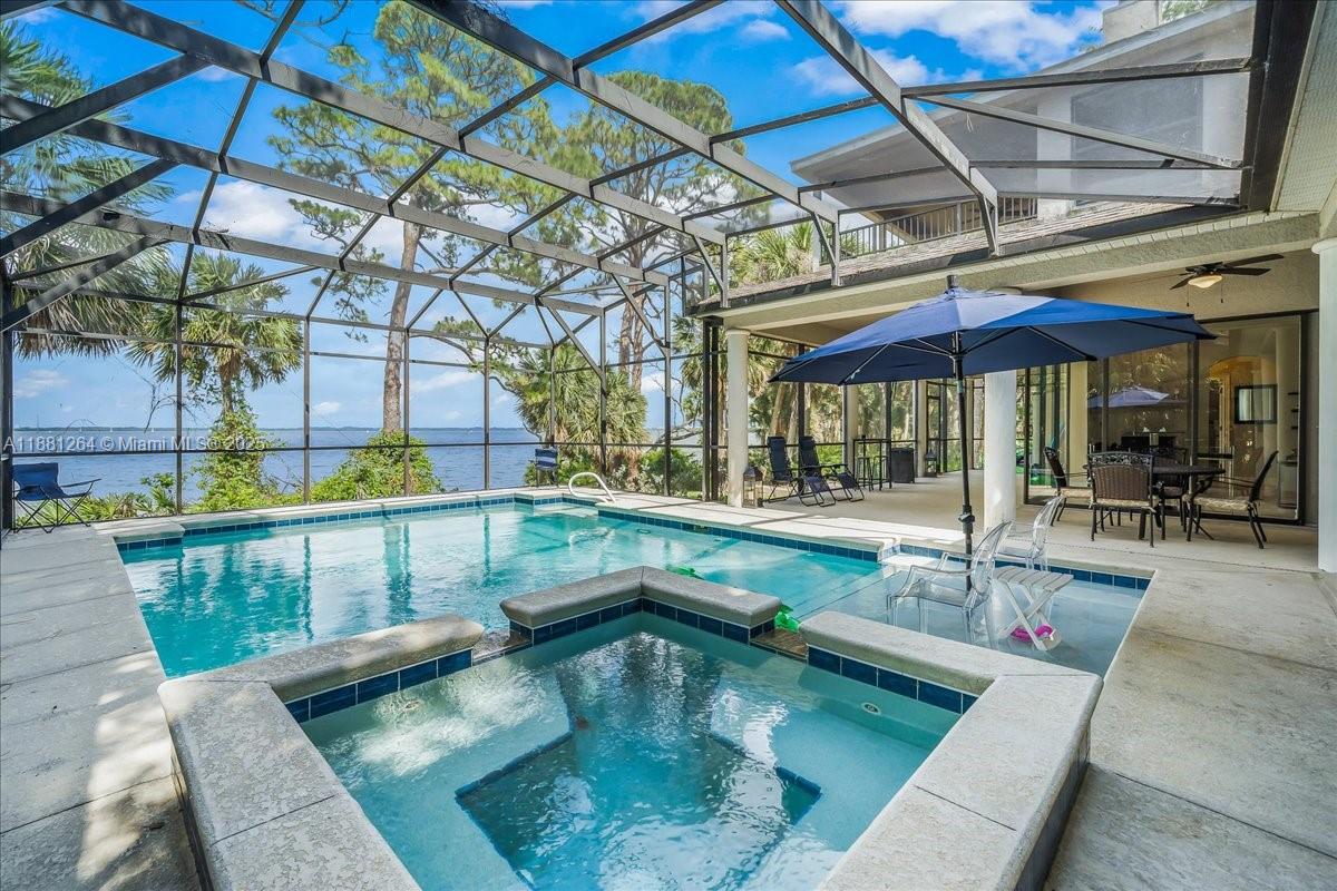 6340 Highway 1 Cocoa, FL 32927 - Photo 3 of 54 a view of a patio with a table and chairs under an umbrella