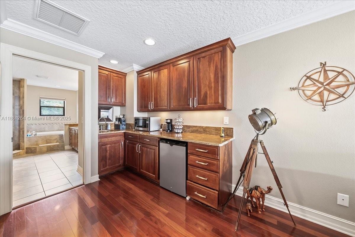 6340 Highway 1 Cocoa, FL 32927 - Photo 33 of 54 a kitchen with a refrigerator a stove and a wooden floor