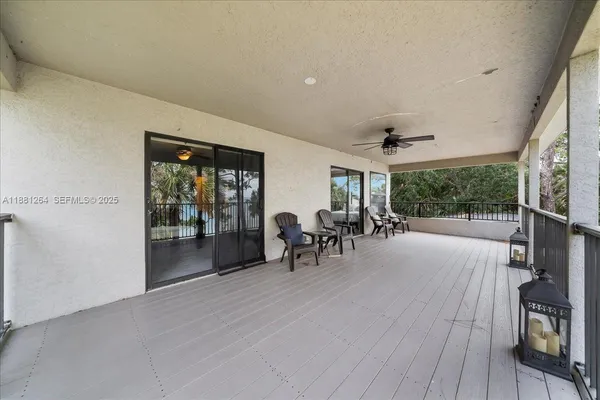 a view of a livingroom with furniture and floor to ceiling window