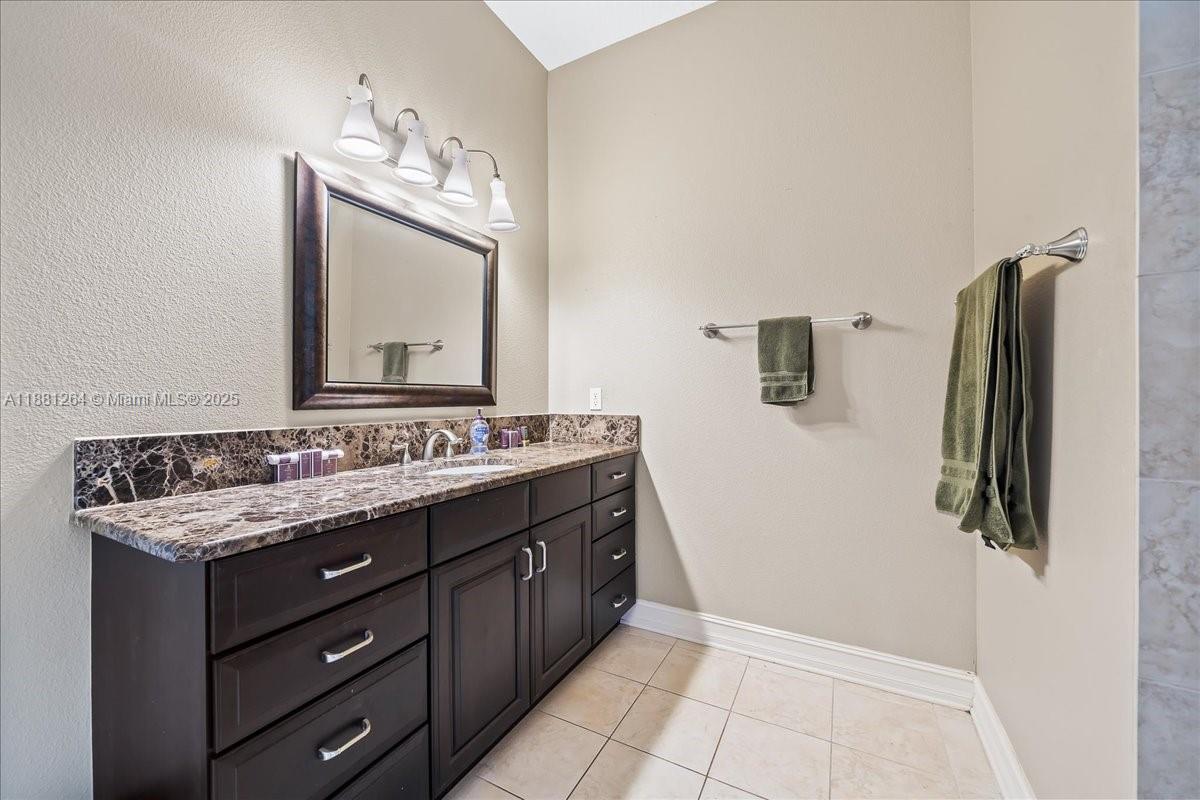 6340 Highway 1 Cocoa, FL 32927 - Photo 44 of 54 a bathroom with a double vanity sink and mirror
