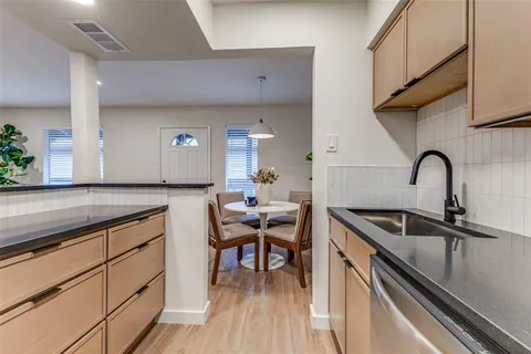 a kitchen with a sink cabinets and wooden floor