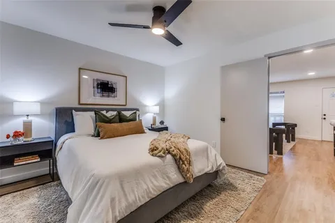 a bedroom with bed and a chandelier