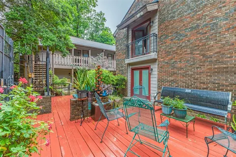 a view of a house with backyard and sitting area