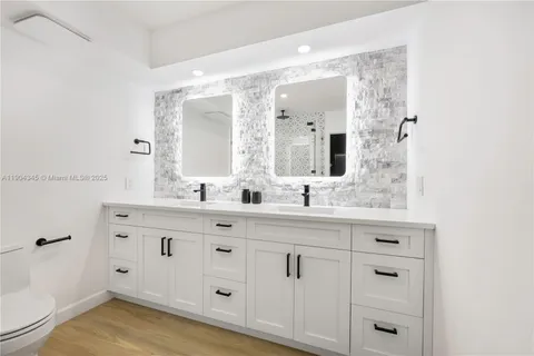 a bathroom with a sink vanity and mirror