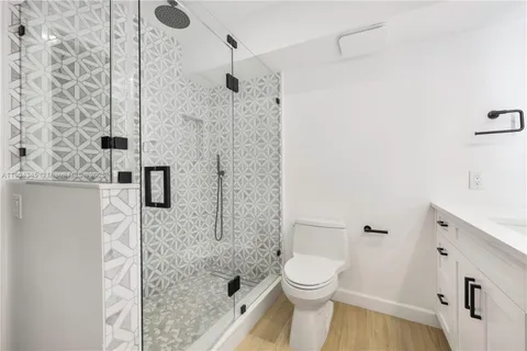 a bathroom with a toilet and a shower