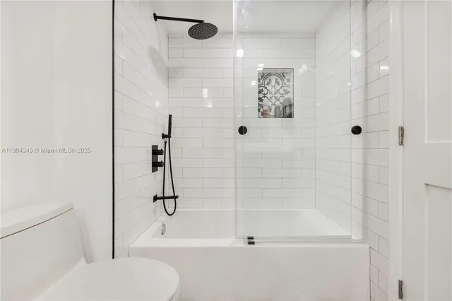 a bathroom with a shower and a toilet