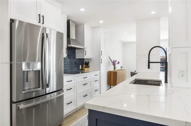 a kitchen with stainless steel appliances a refrigerator sink and cabinets
