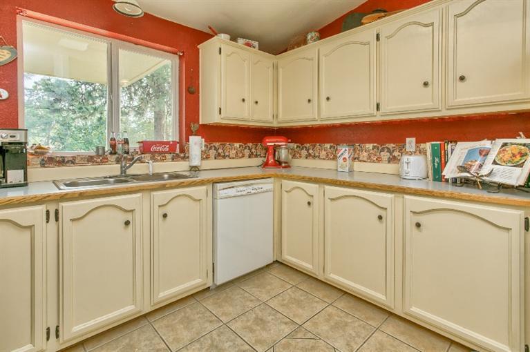 2388 Old Military Road Central Point, OR 97502 - Photo 20 of 35 a kitchen with stainless steel appliances granite countertop a sink and dishwasher with white cabinets
