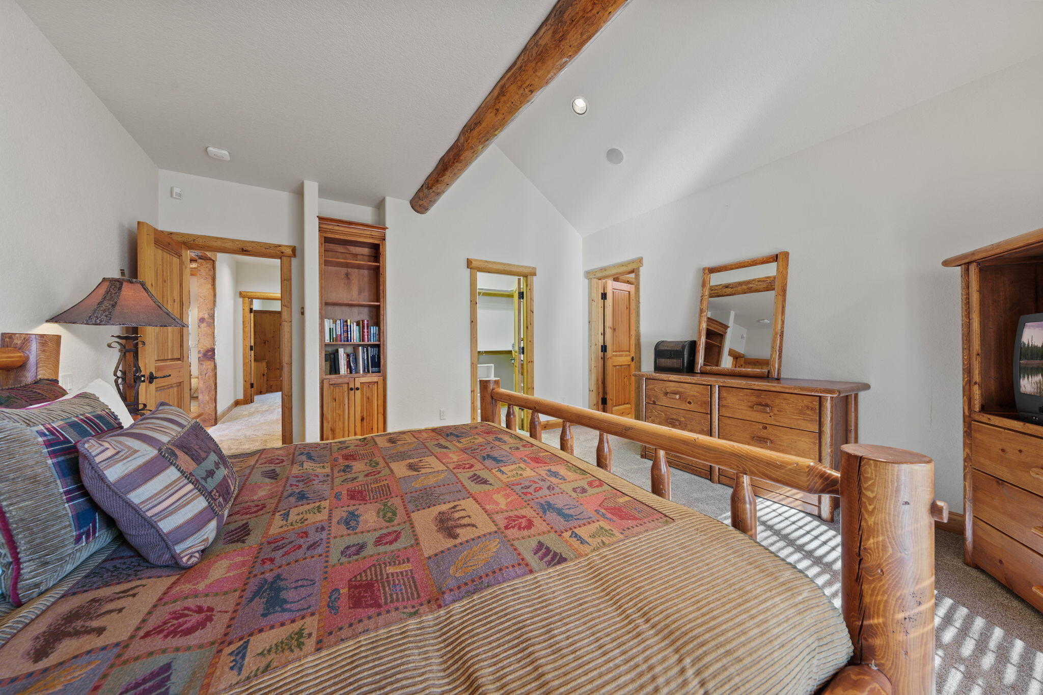 58026 Kinglet Road Sunriver, OR 97707 - Photo 18 of 39 a bedroom with a bed and a flat tv screen on dresser