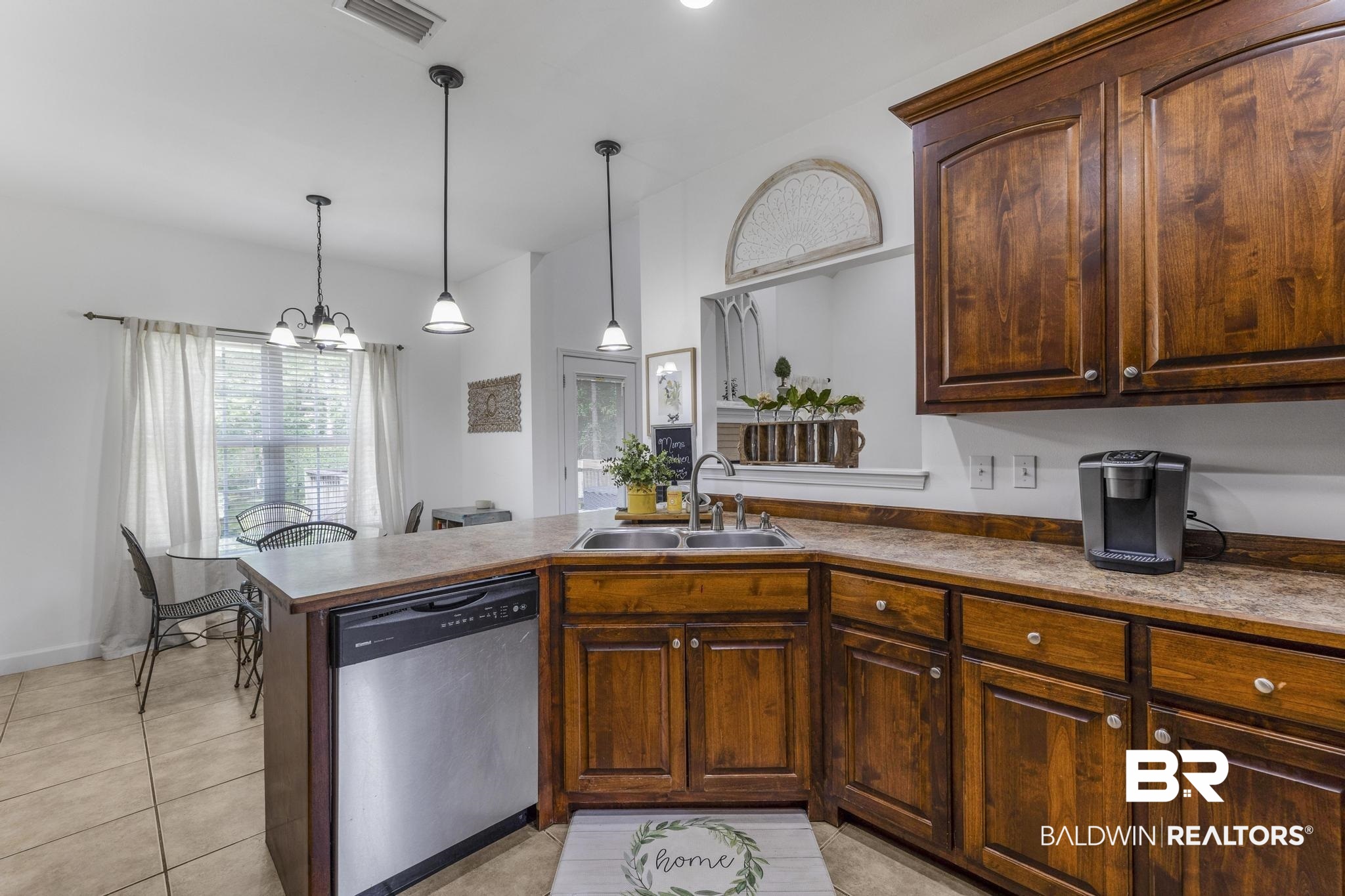 35814 Delvan Lane Bay Minette, AL 36507 - Photo 16 of 53 Kitchen featuring wood cabinetry, a stainless steel dishwasher, a double basin sink, and laminate countertops