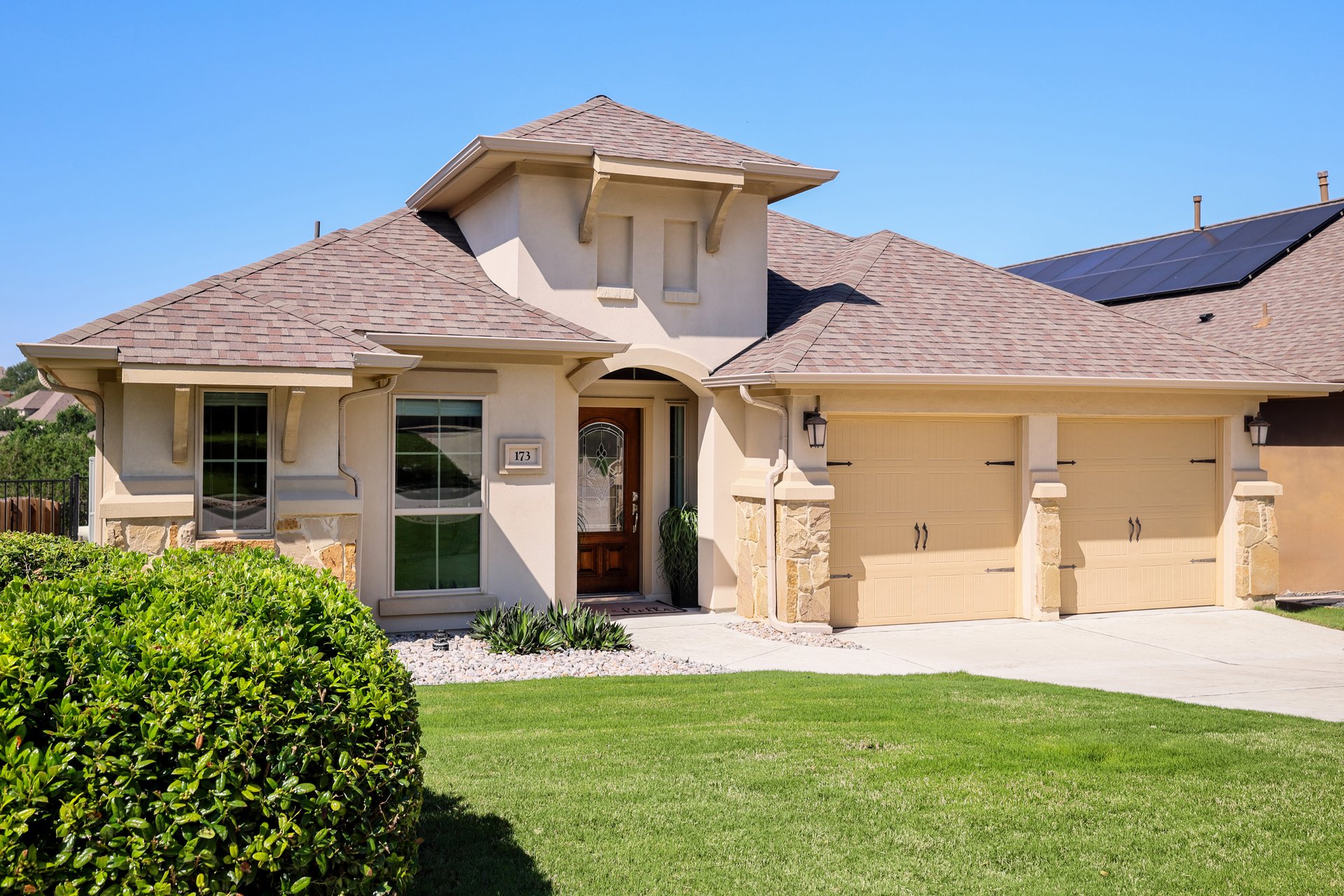173 Santa Maria Street Georgetown, TX 78628 - Photo 7 of 39 Stucco exterior with stone accents and a multi-pitch shingle roof