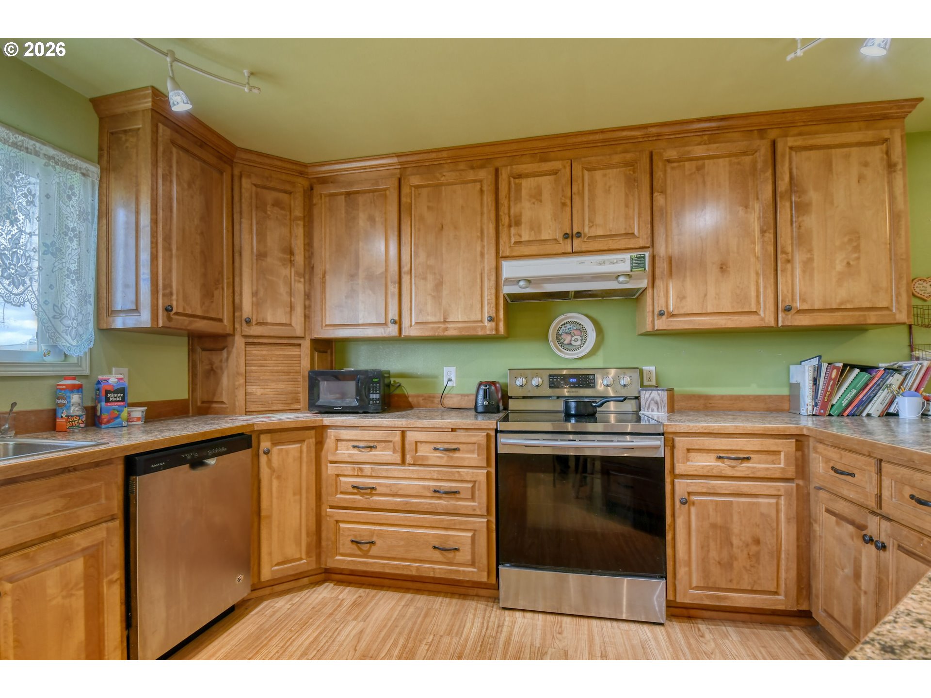 554 West High Street Athena, OR 97813 - Photo 11 of 46 a kitchen with kitchen island a sink a stove and cabinets