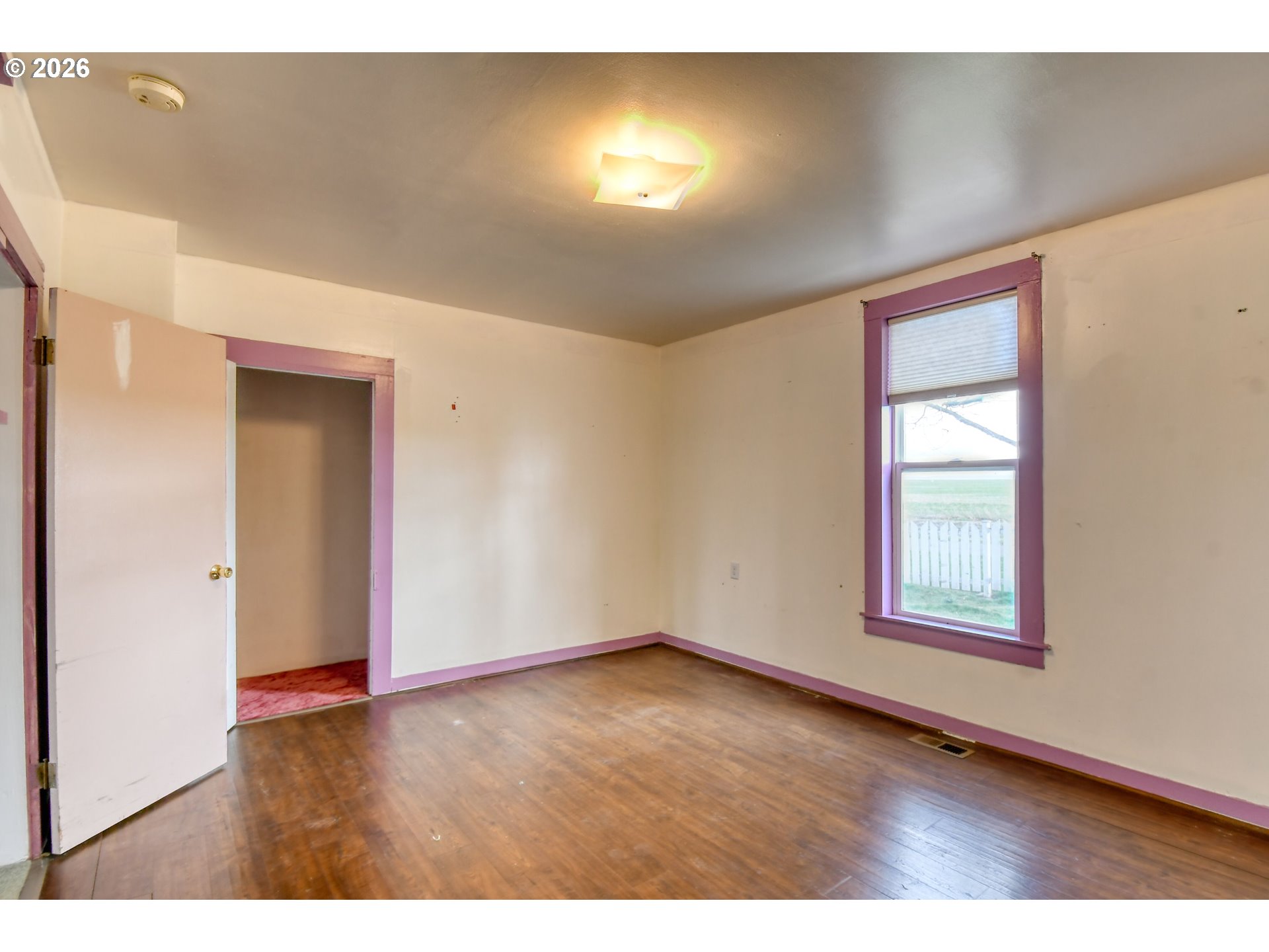 554 West High Street Athena, OR 97813 - Photo 21 of 46 an empty room with wooden floor and windows