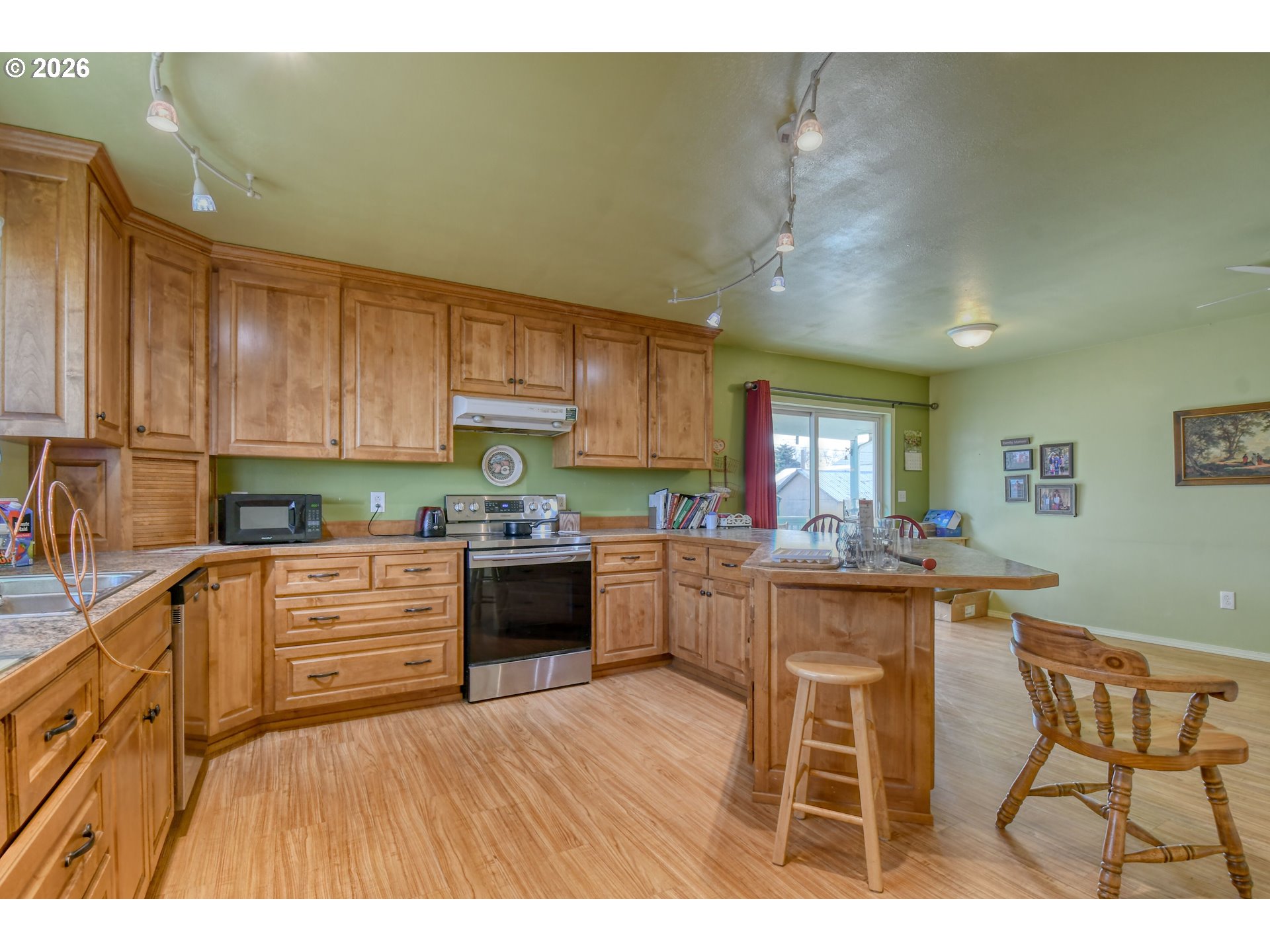 554 West High Street Athena, OR 97813 - Photo 10 of 46 a kitchen with granite countertop wooden cabinets and stainless steel appliances