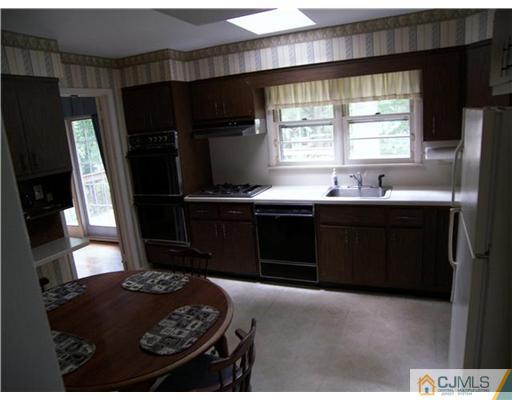 5 Huntington Road Edison, NJ 08820 - Photo 2 of 7 a kitchen with a sink and a stove