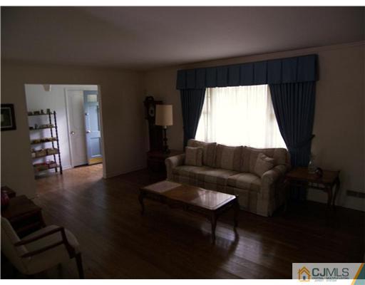 5 Huntington Road Edison, NJ 08820 - Photo 4 of 7 a living room with furniture and a large window