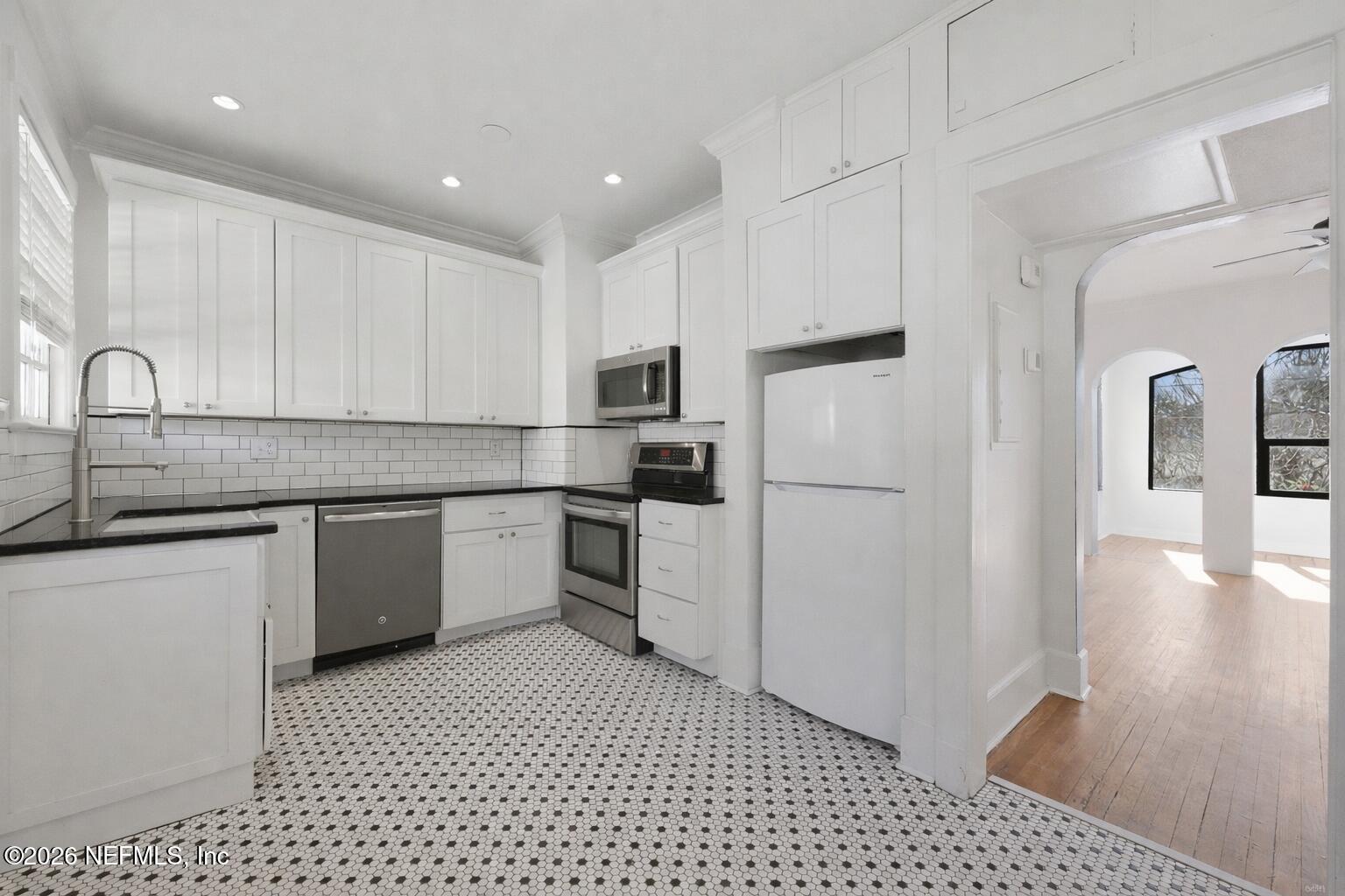 1625 Seminole Road, Unit 1625 Jacksonville, FL 32205 - Photo 12 of 22 a kitchen with a sink a stove a refrigerator and cabinets