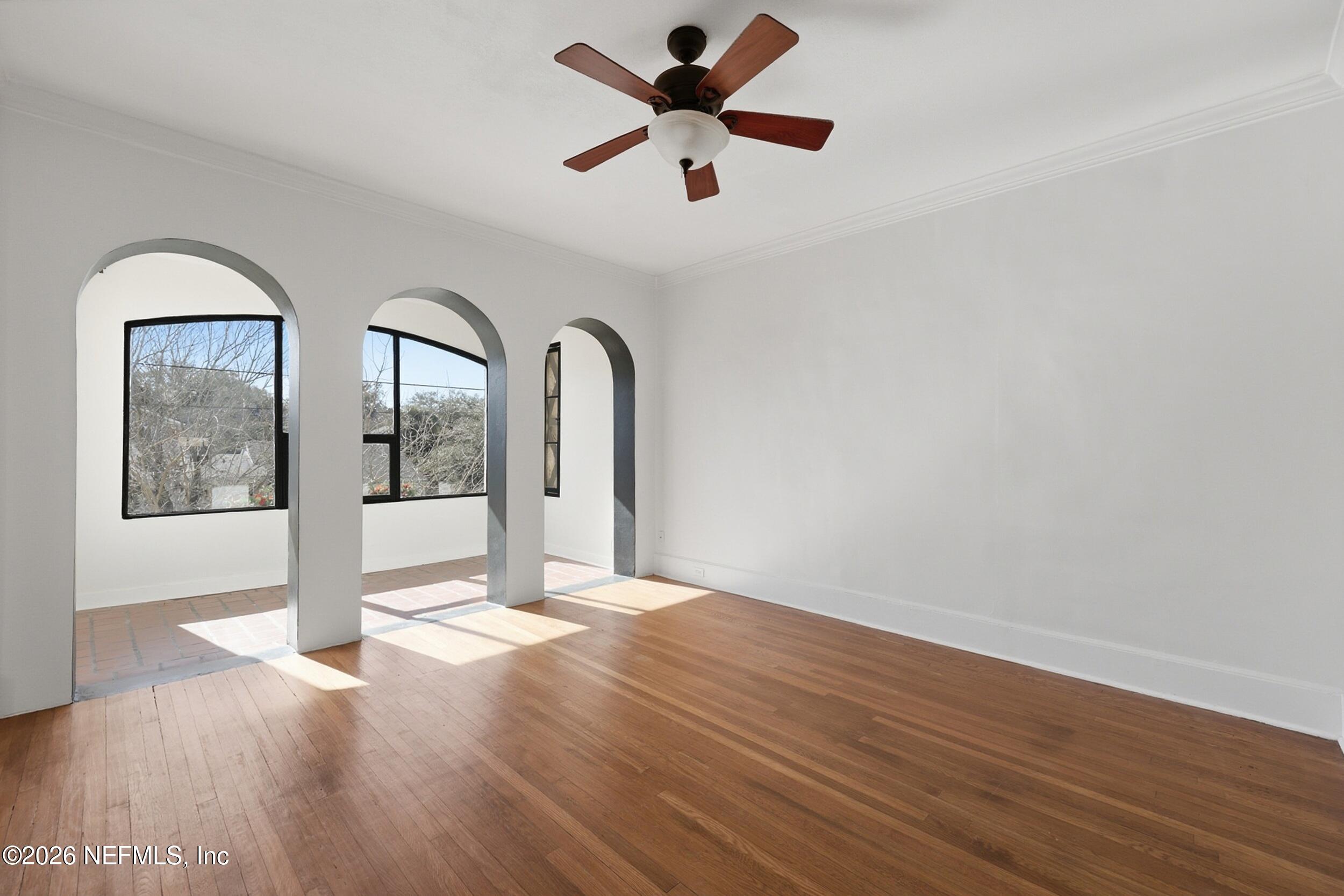 1625 Seminole Road, Unit 1625 Jacksonville, FL 32205 - Photo 6 of 22 a view of an empty room with wooden floor and a ceiling fan