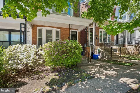 a view of a house with a tree in front