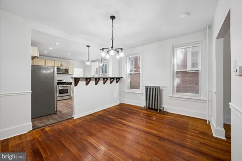 a view of a kitchen with a sink and refrigerator