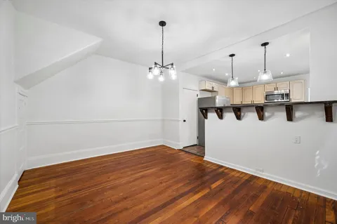 a view of a kitchen with wooden floor