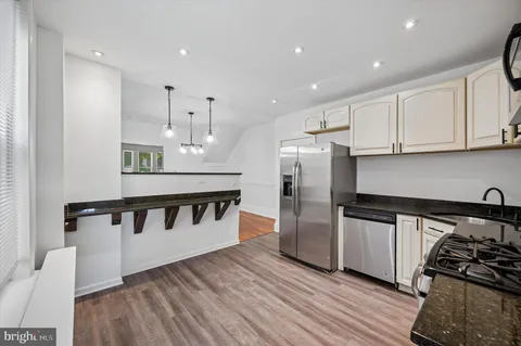 a kitchen with stainless steel appliances a refrigerator and a stove top oven