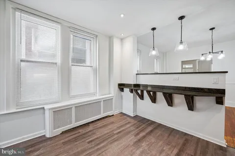 a kitchen with stainless steel appliances granite countertop a stove a sink and a wooden floors