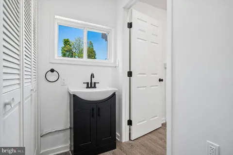 a bathroom with a sink a mirror and a window