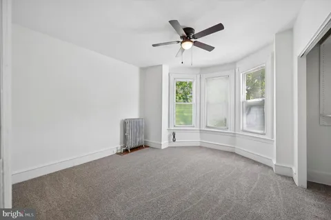 a view of a livingroom with a ceiling fan and window