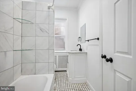 a bathroom with a sink a toilet a shower and bathtub