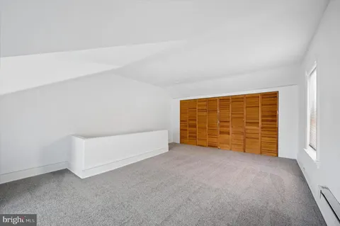 a view of an empty room with a ceiling fan