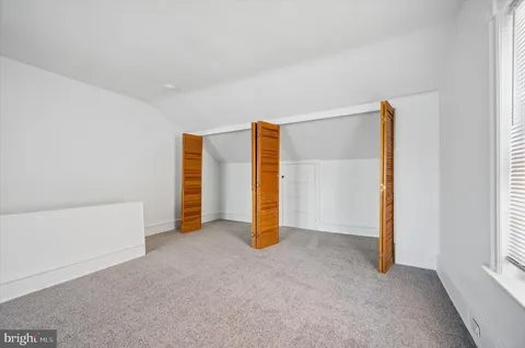 a view of an empty room with closet