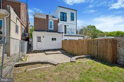a view of a backyard with a fence