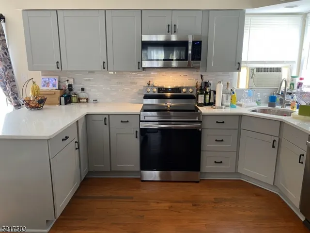 a kitchen with cabinets appliances and a window