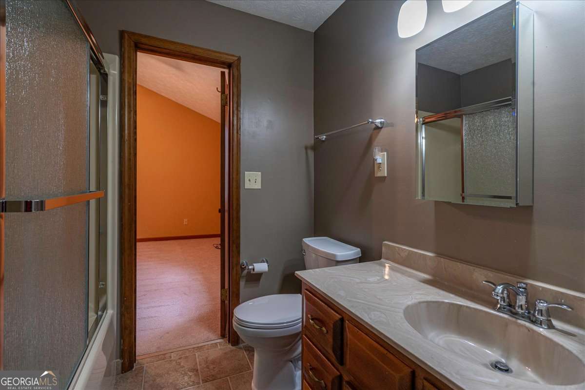 59 Busbin Lane Colbert, GA 30628 - Photo 19 of 29 a bathroom with a sink a toilet and shower