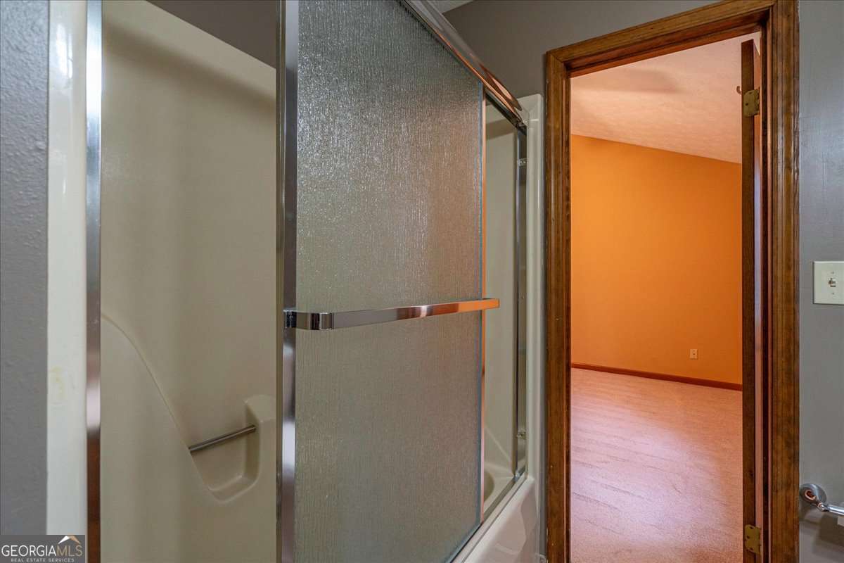 59 Busbin Lane Colbert, GA 30628 - Photo 20 of 29 a bathroom with a glass shower door