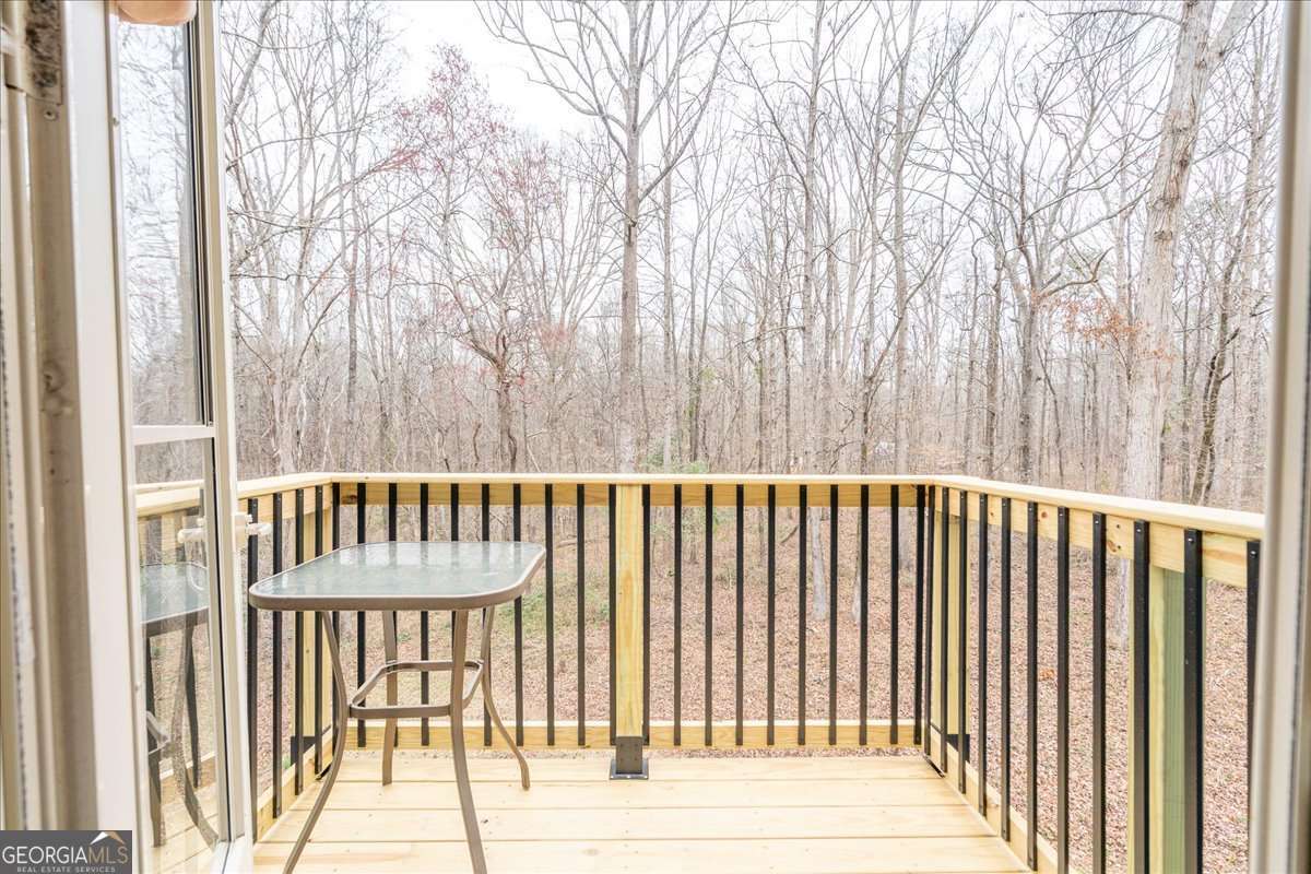 59 Busbin Lane Colbert, GA 30628 - Photo 21 of 29 a balcony with trees in front of it