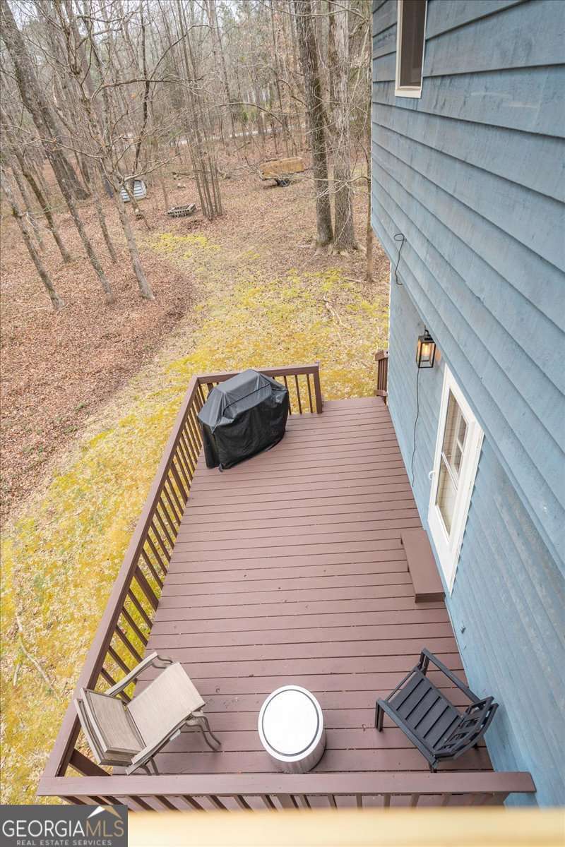 59 Busbin Lane Colbert, GA 30628 - Photo 25 of 29 a view of a balcony with wooden floor and bench