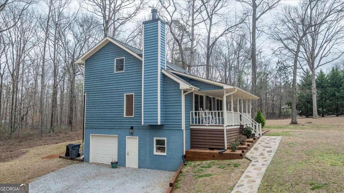 59 Busbin Lane Colbert, GA 30628 - Photo 26 of 29 a front view of a house with a yard