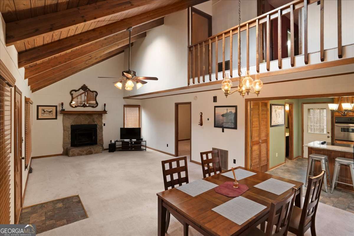 59 Busbin Lane Colbert, GA 30628 - Photo 8 of 29 a living room with furniture a fireplace and kitchen view