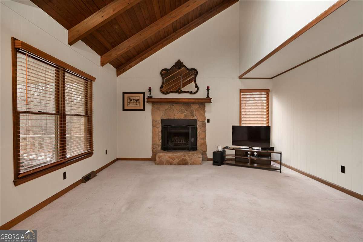 59 Busbin Lane Colbert, GA 30628 - Photo 9 of 29 a living room with furniture a fireplace and a flat screen tv